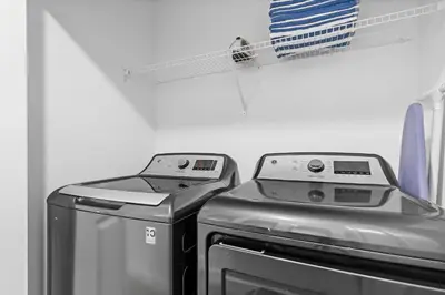 two machines sitting next to each other in a laundry room at Disney Getaway Private Pool Themed Bedrooms. Book Now SLR481 in Kissimmee