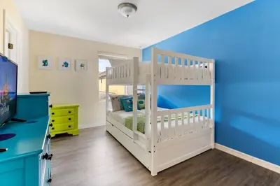 a white crib in a room with a blue wall at Disney Getaway Luxury Villa with Private Pool. Book Now BV75 in Kissimmee