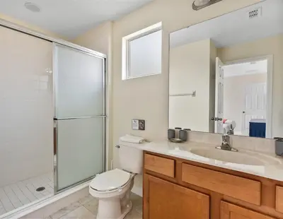 a bathroom with a toilet and a sink and a shower at Disney Getaway Luxury Villa with Private Pool. Book Now BV75 in Kissimmee
