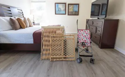 a bedroom with a bed and a cart with a television at Disney Getaway Luxury Villa with Private Pool. Book Now BV75 in Kissimmee