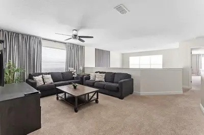 a living room with a couch and a table at Disney Private Pool Hot Tub Game Room Themed Bedrooms. Book Now SLR497 in Kissimmee