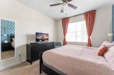 a bedroom with a bed and a ceiling fan at Disney Private Pool Hot Tub Game Room Themed Bedrooms. Book Now SLR497 in Kissimmee