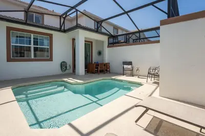 a swimming pool in the backyard of a house at Disney Getaway Private Pool Themed Bedrooms. Book Now SLR503 in Kissimmee