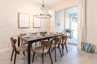 a dining room with a black table and chairs at Disney Getaway Private Pool Themed Bedrooms. Book Now SLR377 in Kissimmee