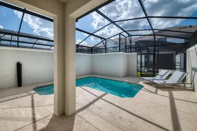 a swimming pool in a house with a glass ceiling at Disney Getaway Private Pool Themed Bedrooms. Book Now SLR377 in Kissimmee