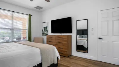 a bedroom with a bed and a television on a wall at Disney Private Pool Hot Tub Game Room Themed Bedrooms. Book Now EIR179 in Kissimmee