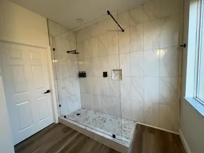 a bathroom with a shower with a bench in it at Disney Private Pool Hot Tub Game Room Themed Bedrooms. Book Now EIR179 in Kissimmee