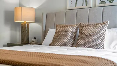 a bedroom with a bed with pillows and a lamp at Disney Private Pool Hot Tub Game Room Themed Bedrooms. Book Now EIR179 in Kissimmee