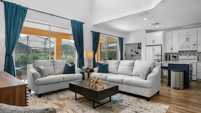 a living room with two couches and a table at Disney Private Pool Hot Tub Game Room Themed Bedrooms. Book Now EIR179 in Kissimmee