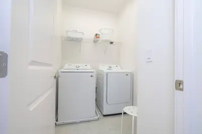 a white laundry room with two washing machines in it at Disney Getaway Private Pool Themed Bedrooms. Book Now BV241 in Kissimmee