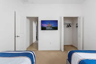 a room with two beds and a tv on the wall at Disney Getaway Private Pool Game Room. Book Now BV77 in Kissimmee