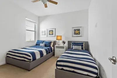 a bedroom with two beds and a ceiling fan at Disney Getaway Private Pool Game Room. Book Now BV77 in Kissimmee