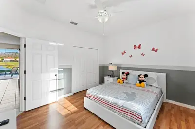 a bedroom with a bed with two stuffed animals on it at Disney Private Pool Hot Tub Themed Bedrooms. Book Now BV76 in Kissimmee