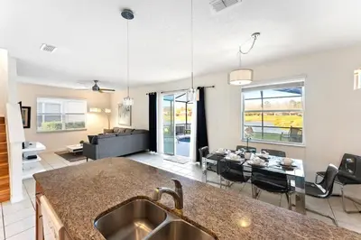 a kitchen and living room with a table and a couch at Disney Private Pool Hot Tub Themed Bedrooms. Book Now BV76 in Kissimmee