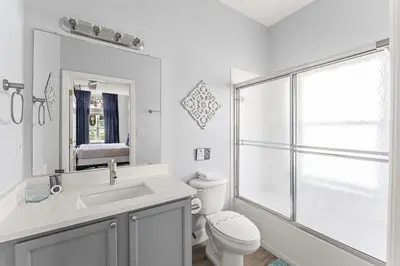 a bathroom with a toilet and a sink and a shower at Disney Getaway Private Pool Themed Bedrooms. Book Now EIR67 in Kissimmee