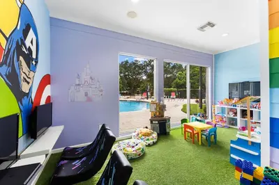 a childrens room with a pool and a playroom with green carpet at Disney Getaway Private Pool Themed Bedrooms. Book Now LV8 in Kissimmee