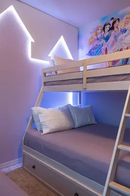 a childs bedroom with a bunk bed with a ladder at Disney Getaway Private Pool Themed Bedrooms. Book Now WLV83 in Kissimmee