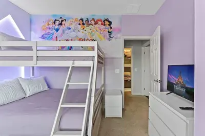 a bedroom with a bunk bed with a purple wall at Disney Getaway Private Pool Themed Bedrooms. Book Now WLV83 in Kissimmee