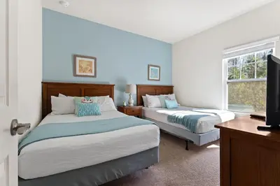 a bedroom with two beds and a flat screen tv at Disney Getaway Private Pool Themed Bedrooms. Book Now WLV19 in Kissimmee