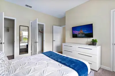 a bedroom with a bed and a tv on the wall at Disney Getaway Private Pool Themed Bedrooms. Book Now SLR506 in Kissimmee