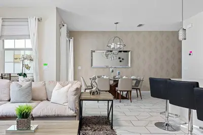 a living room with a couch and a table at Disney Getaway Private Pool Themed Bedrooms. Book Now SLR506 in Kissimmee