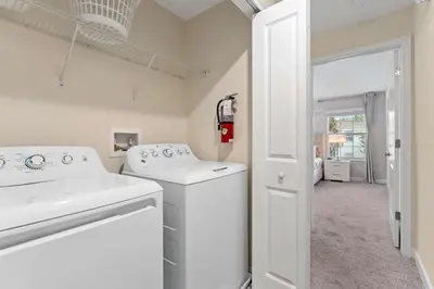 a white laundry room with a washer and dryer at Disney Getaway Private Pool Themed Bedrooms. Book Now SLR506 in Kissimmee