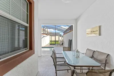 a dining room with a glass table and chairs at Disney Getaway Private Pool Themed Bedrooms. Book Now SLR506 in Kissimmee