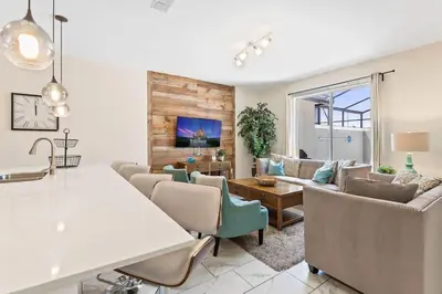a living room with couches and a table at Disney Getaway Townhouse with Private Pool. Book Now SLR504 in Kissimmee