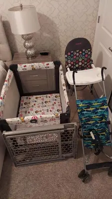 a room with a crib and a chair and a lamp at Disney Getaway Private Pool Themed Bedrooms. Book Now SLR505 in Kissimmee