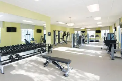 a gym with treadmills and machines in a room at Disney Getaway Private Pool Themed Bedrooms. Book Now SLR505 in Kissimmee