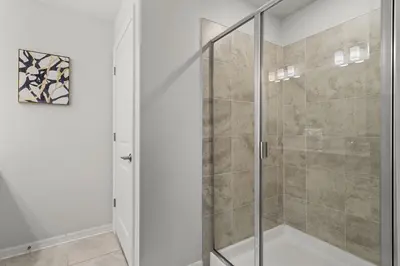 a shower with a glass door in a bathroom at Disney Getaway Luxury Condo with Private Balcony. Book Now SLR507 in Kissimmee
