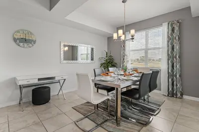 a dining room with a table and chairs at Disney Getaway Luxury Condo with Private Balcony. Book Now SLR507 in Kissimmee