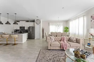 a living room with a couch and a table and a kitchen at Disney Getaway Private Pool Themed Bedrooms. Book Now SLR499 in Kissimmee