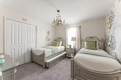 a bedroom with two beds and a chandelier at Disney Getaway Private Pool Themed Bedrooms. Book Now SLR499 in Kissimmee