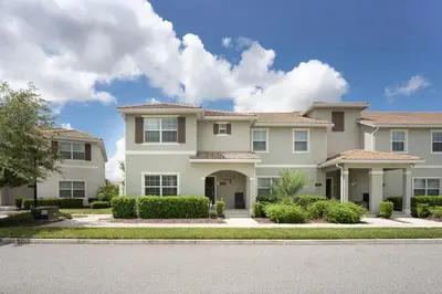 a large white house with bushes and trees at Disney Getaway Private Pool Themed Bedrooms. Book Now SLR499 in Kissimmee