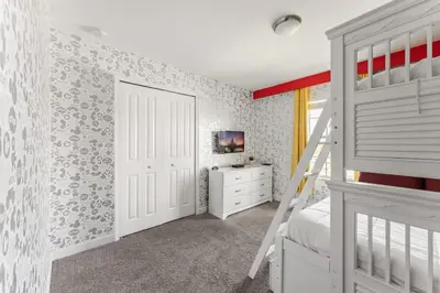 a bedroom with a white bunk bed and a ladder at Disney Getaway Villa with Private Pool Hot Tub. Book Now SLR502 in Kissimmee
