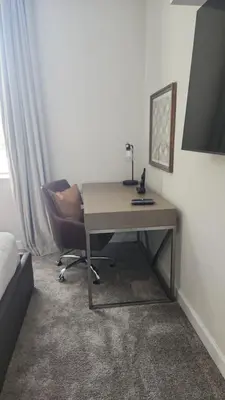 a desk and a chair in a room at Disney Private Pool Game Room Themed Bedrooms. Book Now SLR493 in Kissimmee