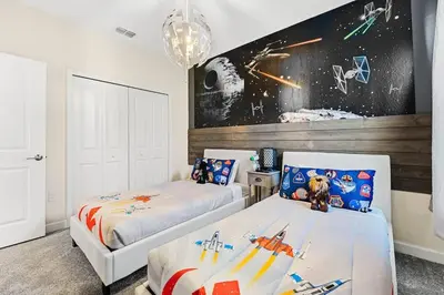 a bedroom with two beds and an astronaut mural at Disney Private Pool Hot Tub Themed Bedrooms. Book Now SLR494 in Kissimmee
