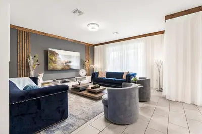 a living room with two blue couches and a tv at Disney Private Pool Hot Tub Themed Bedrooms. Book Now SLR494 in Kissimmee