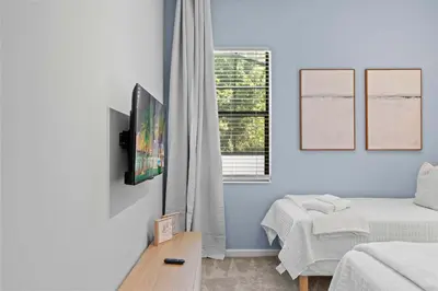 a bedroom with a bed and a tv on a wall at Disney Getaway Private Pool Themed Bedrooms. Book Now PG54 in Orlando