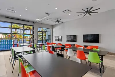 a dining room with tables and colorful chairs at Disney Getaway Private Pool Themed Bedrooms. Book Now PG54 in Orlando