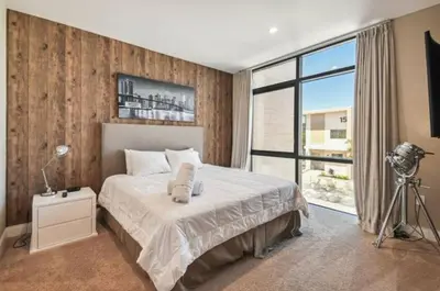 a bedroom with a bed and a large window at Disney Getaway Townhouse with Private Pool. Book Now MVV18 in Orlando
