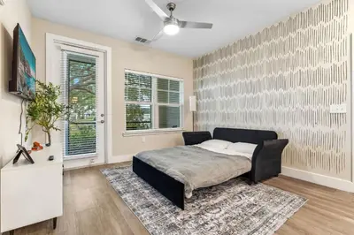 a bedroom with a bed and a window at Pinnacle Apartments W Amenties by Heavenly Homes in Orlando