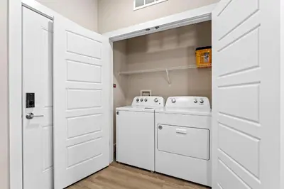 a laundry room with a washer and dryer at Pinnacle Apartments W Amenties by Heavenly Homes in Orlando