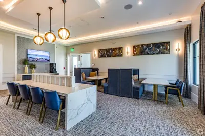 a dining room with two tables and chairs at Pinnacle Apartments W Amenties by Heavenly Homes in Orlando