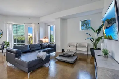 a living room with a couch and a table at 3 bedroom Corner Suite in Orlando