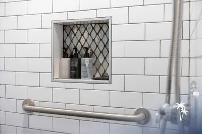 a shelf with bottles of wine in a bathroom at Volcano View 2 Bed 2 Bath Condo with Balcony in Orlando