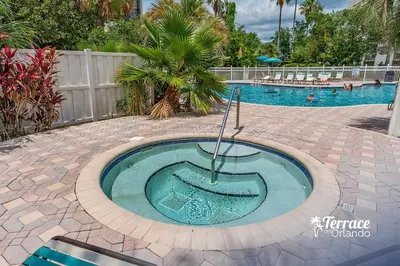 a swimming pool with a circular poolvisor in the middle at Volcano View 2 Bed 2 Bath Condo with Balcony in Orlando