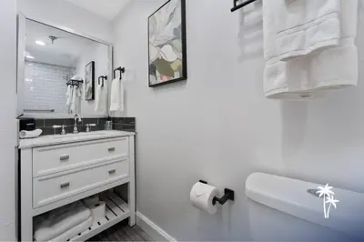 a white bathroom with a sink and a mirror at Volcano View 2 Bed 2 Bath Condo with Balcony in Orlando