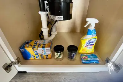 a shelf in a bathroom with toilet paper and cleaning products at Volcano View 2 Bed 2 Bath Condo with Balcony in Orlando